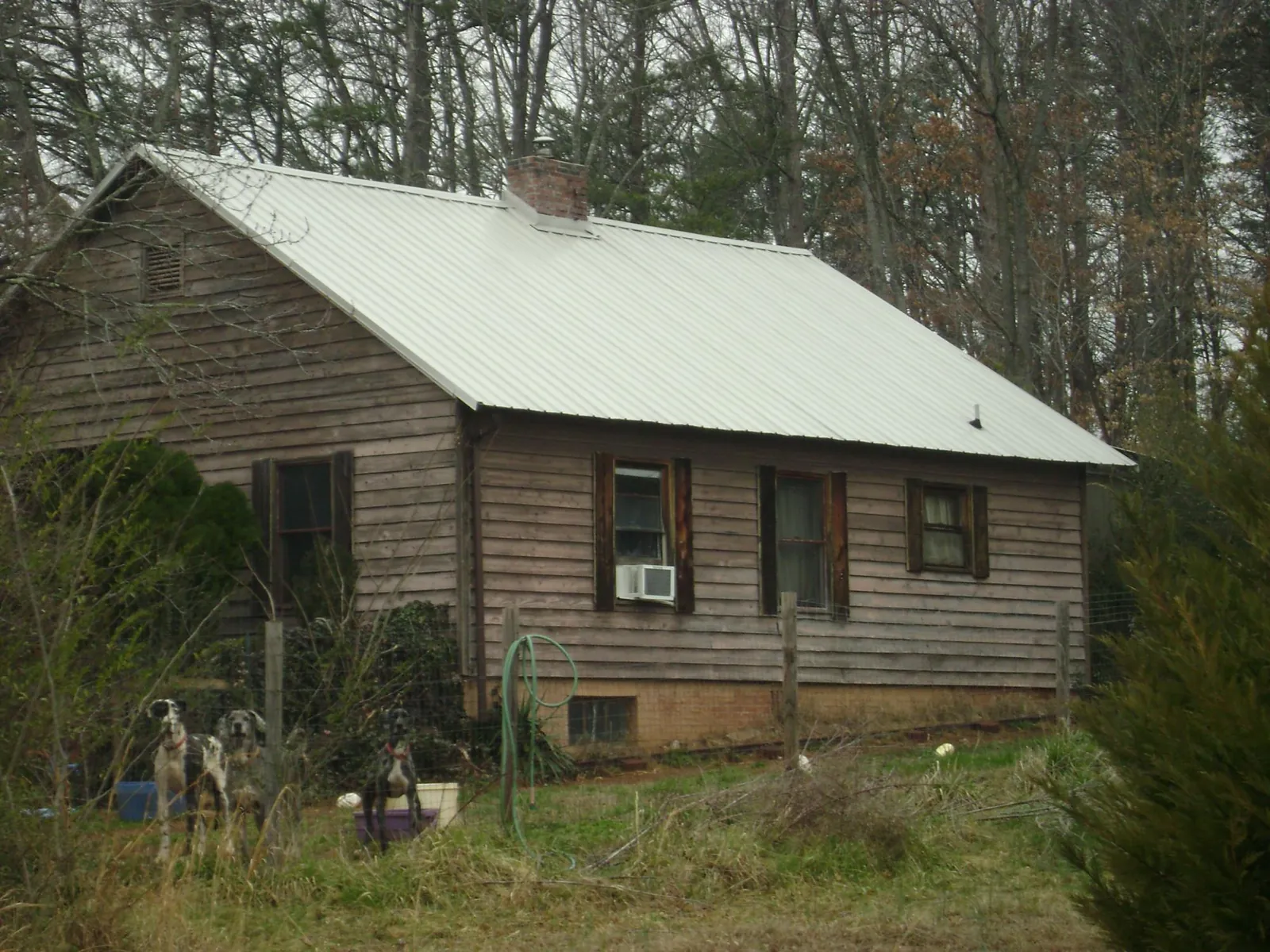 White metal roof on an old wood sided farmhouse, from a Metal Roof Installation job in Dorothy